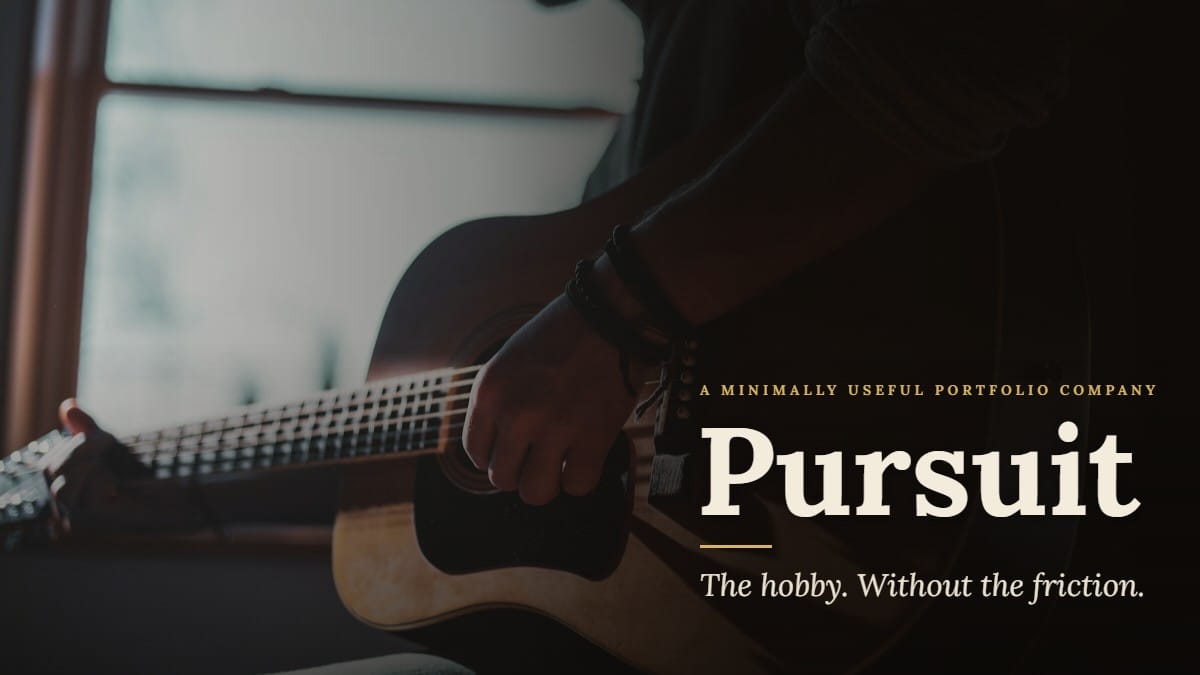 A guitarist playing an acoustic guitar beside a sunlit window