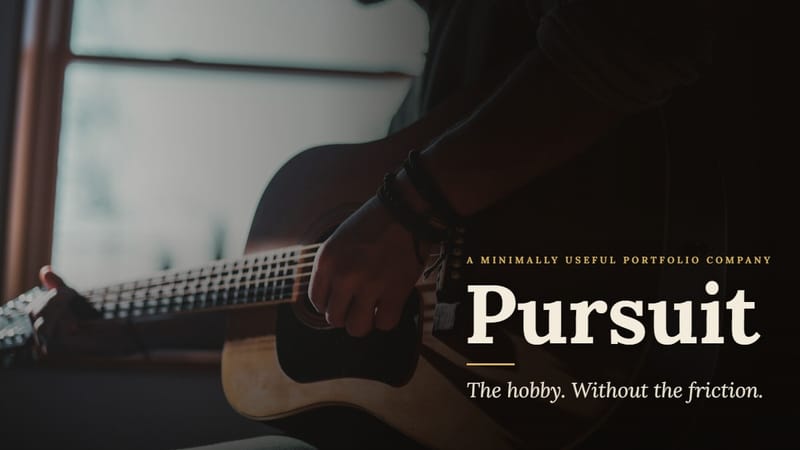A guitarist playing an acoustic guitar beside a sunlit window